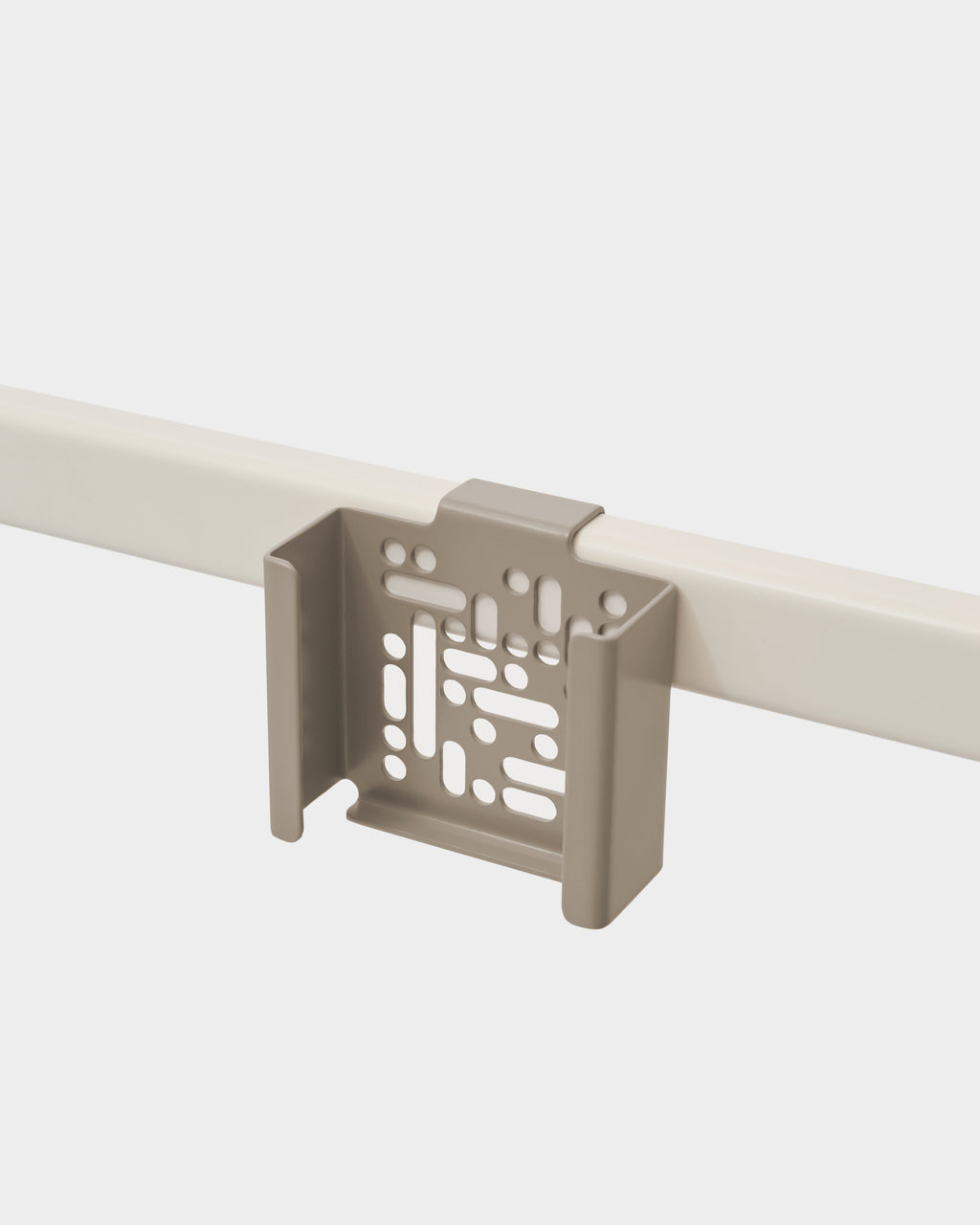Oat Apple TV 4K Mount clipped onto a cream desk rail in a studio packshot, angled view showing vented bracket