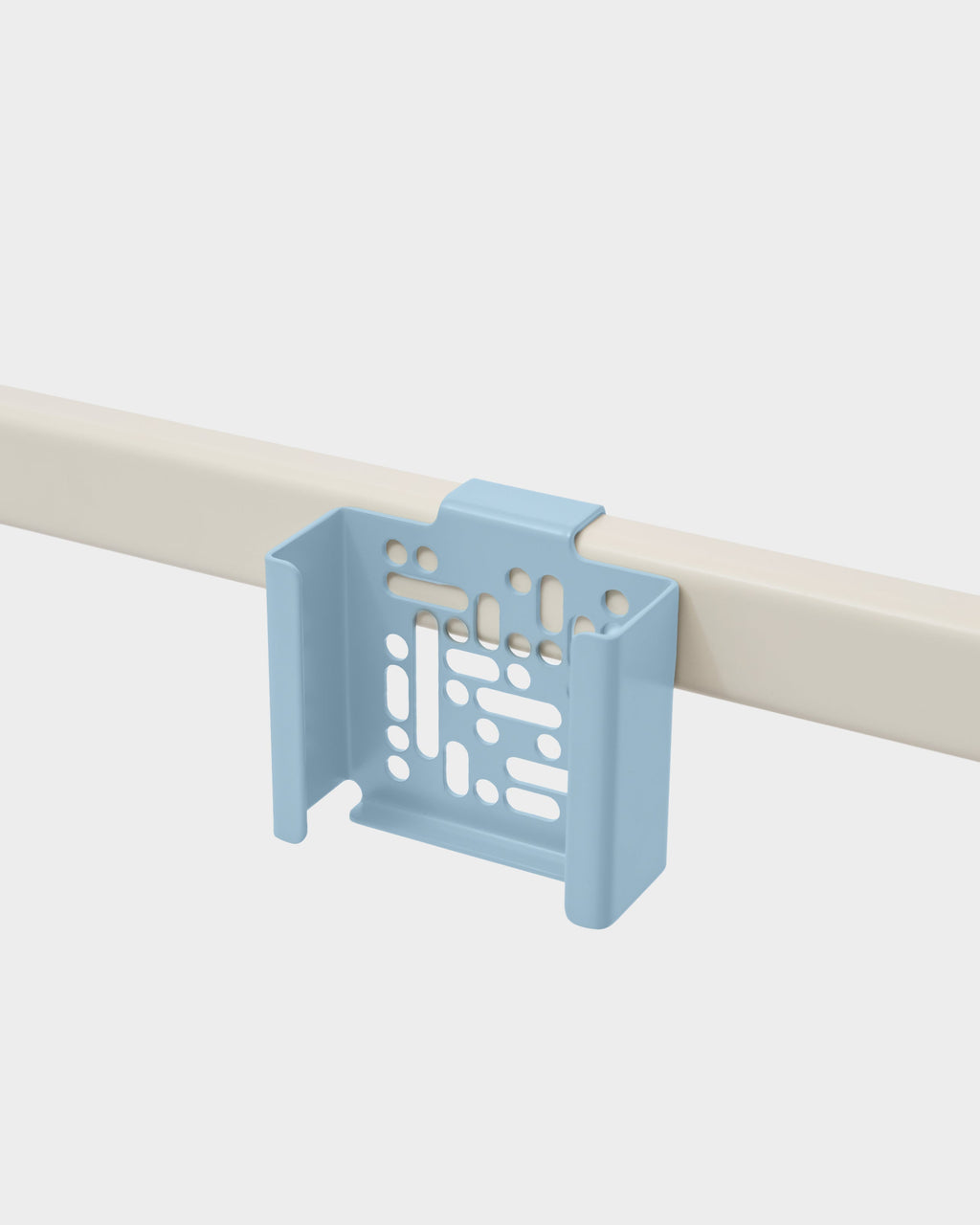Powder Blue Apple TV 4K Mount clipped onto a beige rail, angled studio view showing vented back plate