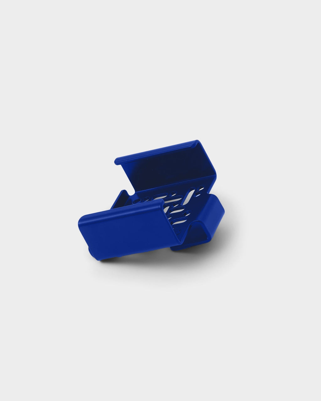 Ultra Marine Apple TV Mount shown at an angle in a studio packshot, revealing vented interior and folded steel edges