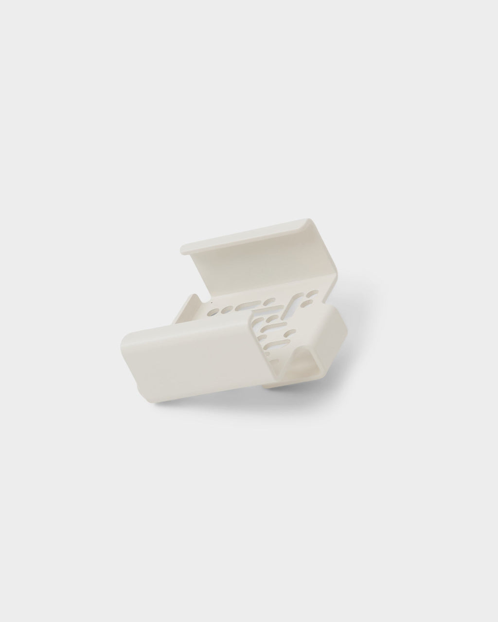 Pearl Apple TV Mount studio packshot, rear three-quarter angle showing vented cutouts and bracket channel on white
```