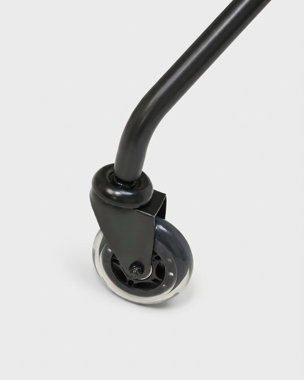Close-up studio detail of a black Blade Wheels caster with clear polyurethane roller attached to a curved chair leg