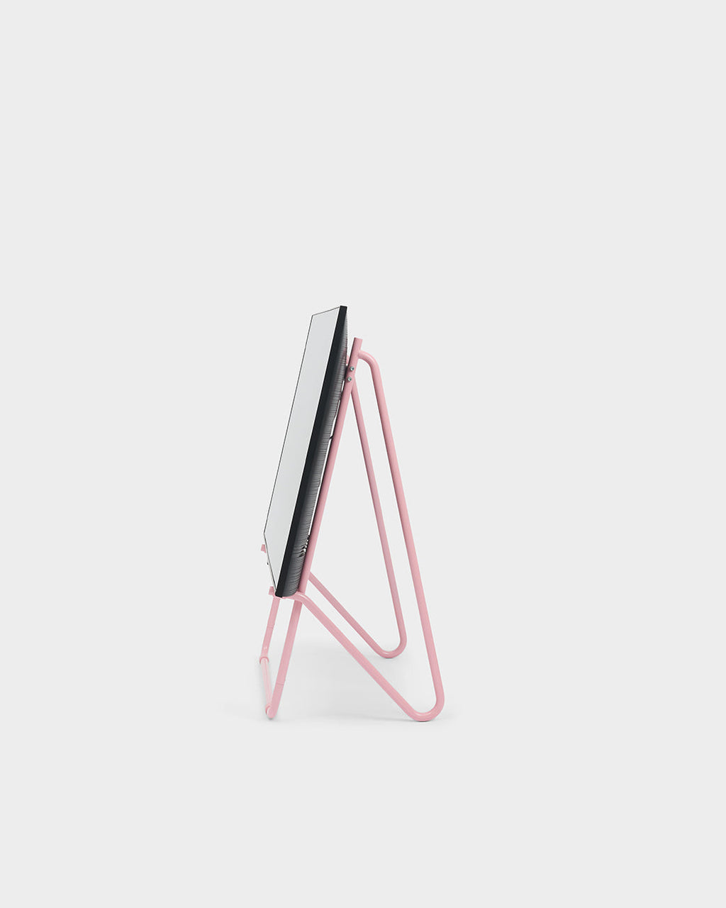 Side profile studio packshot of Bloom in Bubble Gum low stand, pink tubular easel legs supporting a slim flat panel