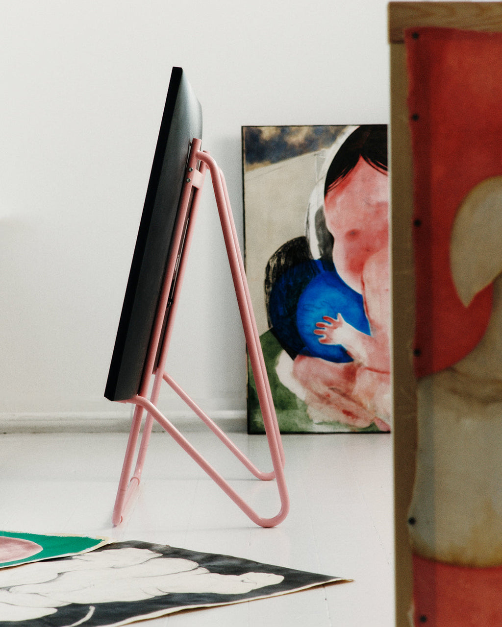Bloom in Bubble Gum (Stands Low) shown from behind in an artist's studio, pink tubular legs supporting a screen