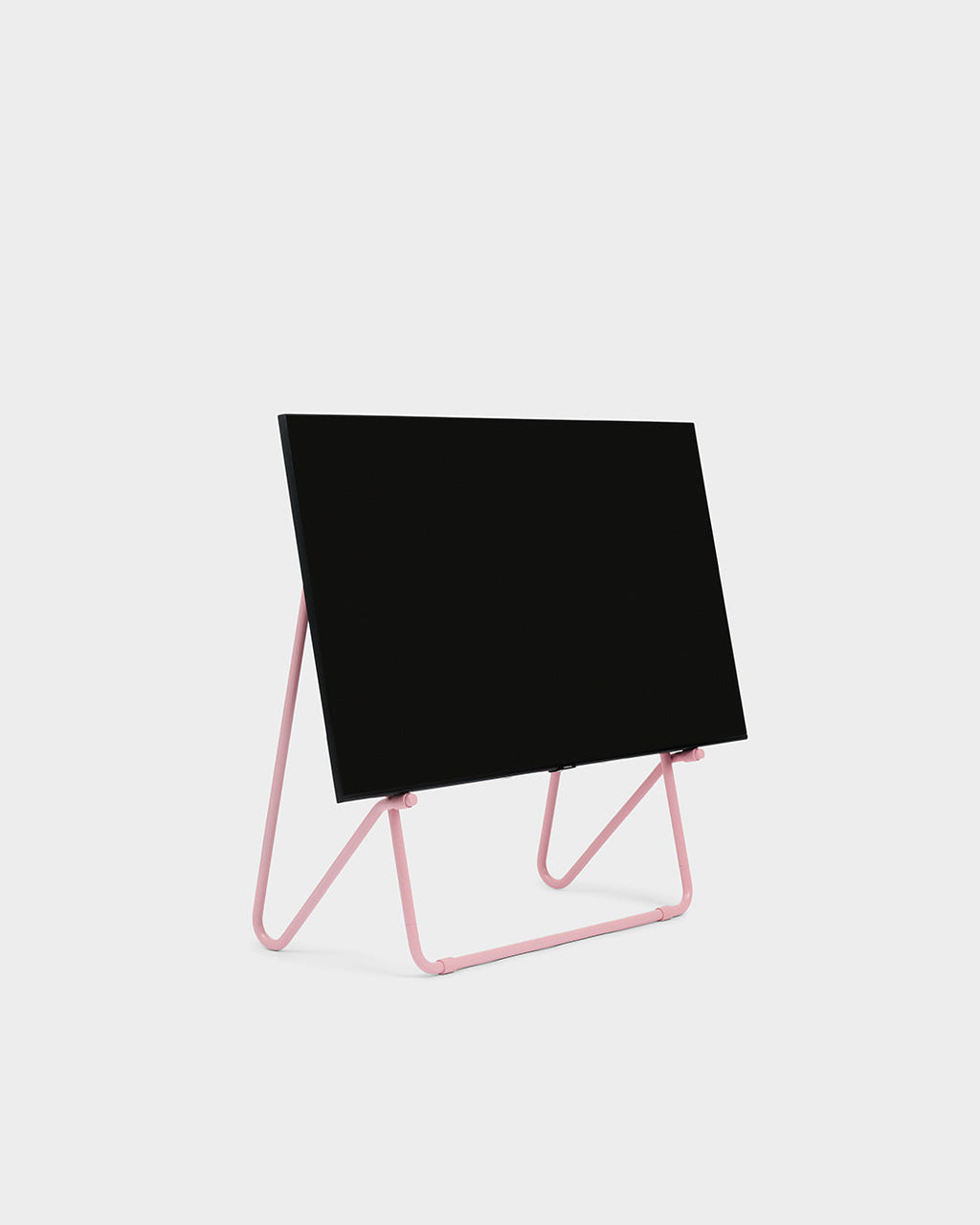 Bloom in Bubble Gum low stand holding a black flat-screen TV, angled studio packshot on a plain white background