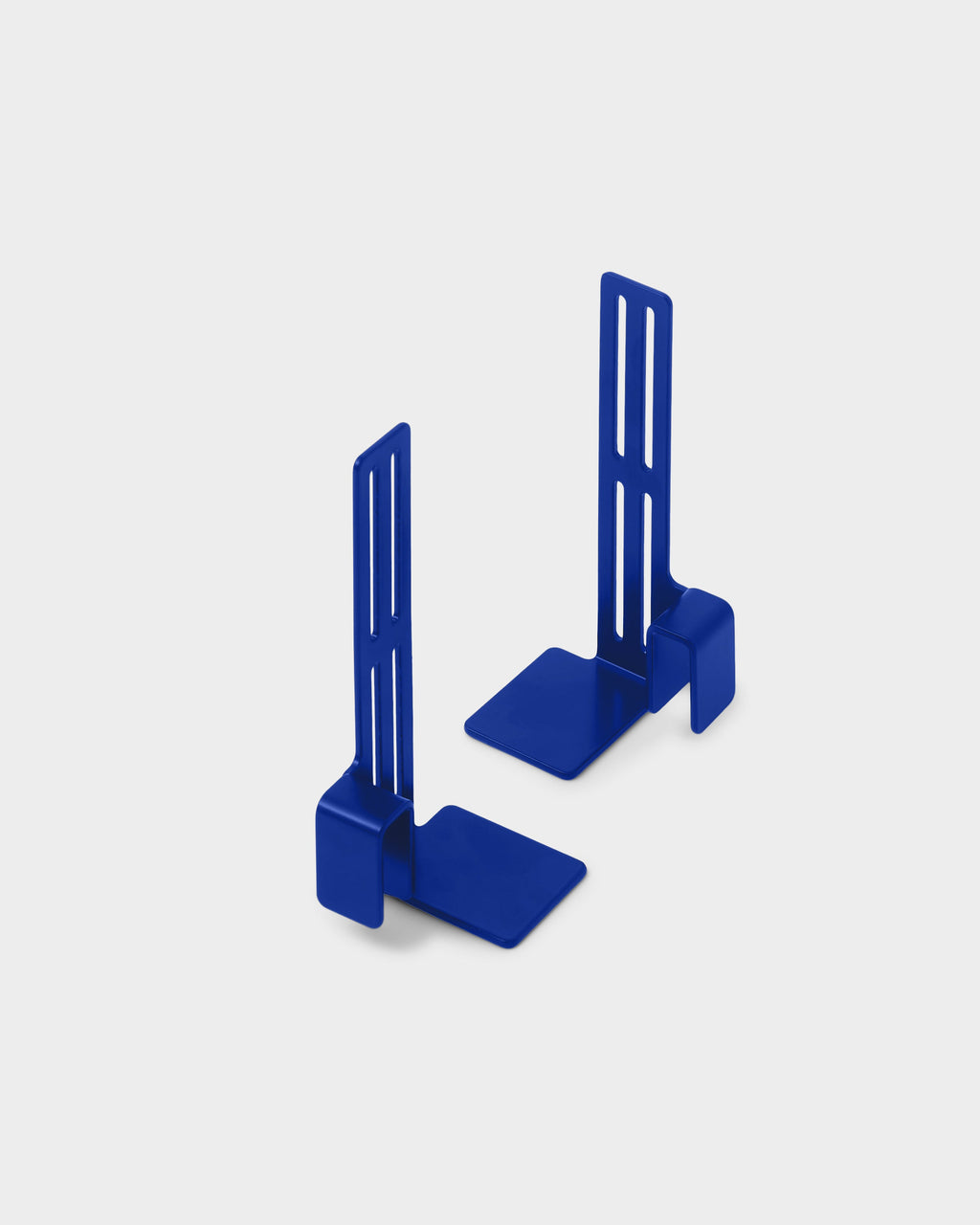 Pair of Ultra Marine Box Mount brackets angled upright on a light studio backdrop, slotted arms and flat bases in view