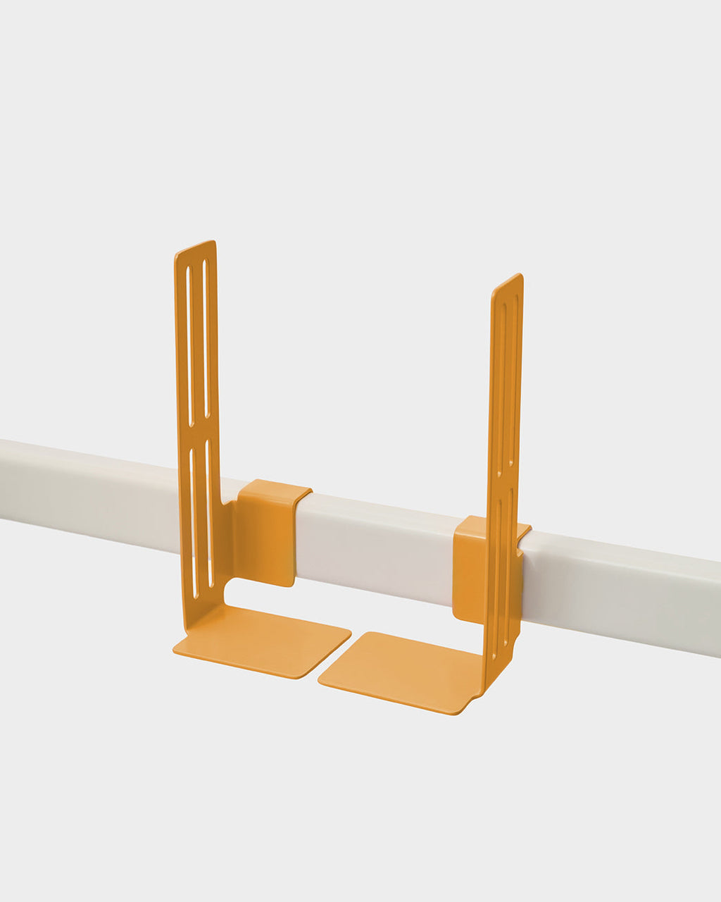 Apricot Box Mount brackets clipped onto a white rail in a studio packshot, angled view showing slotted arms and flat base
