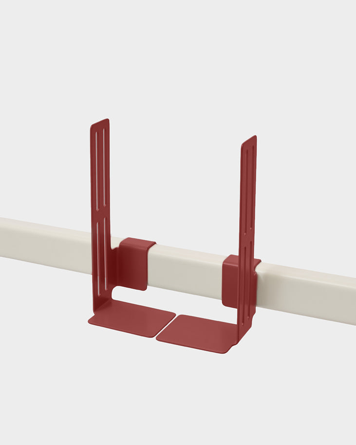 Box Mount in Burnin' Red clamped onto a white rail, angled studio packshot showing slotted brackets and flat base plates