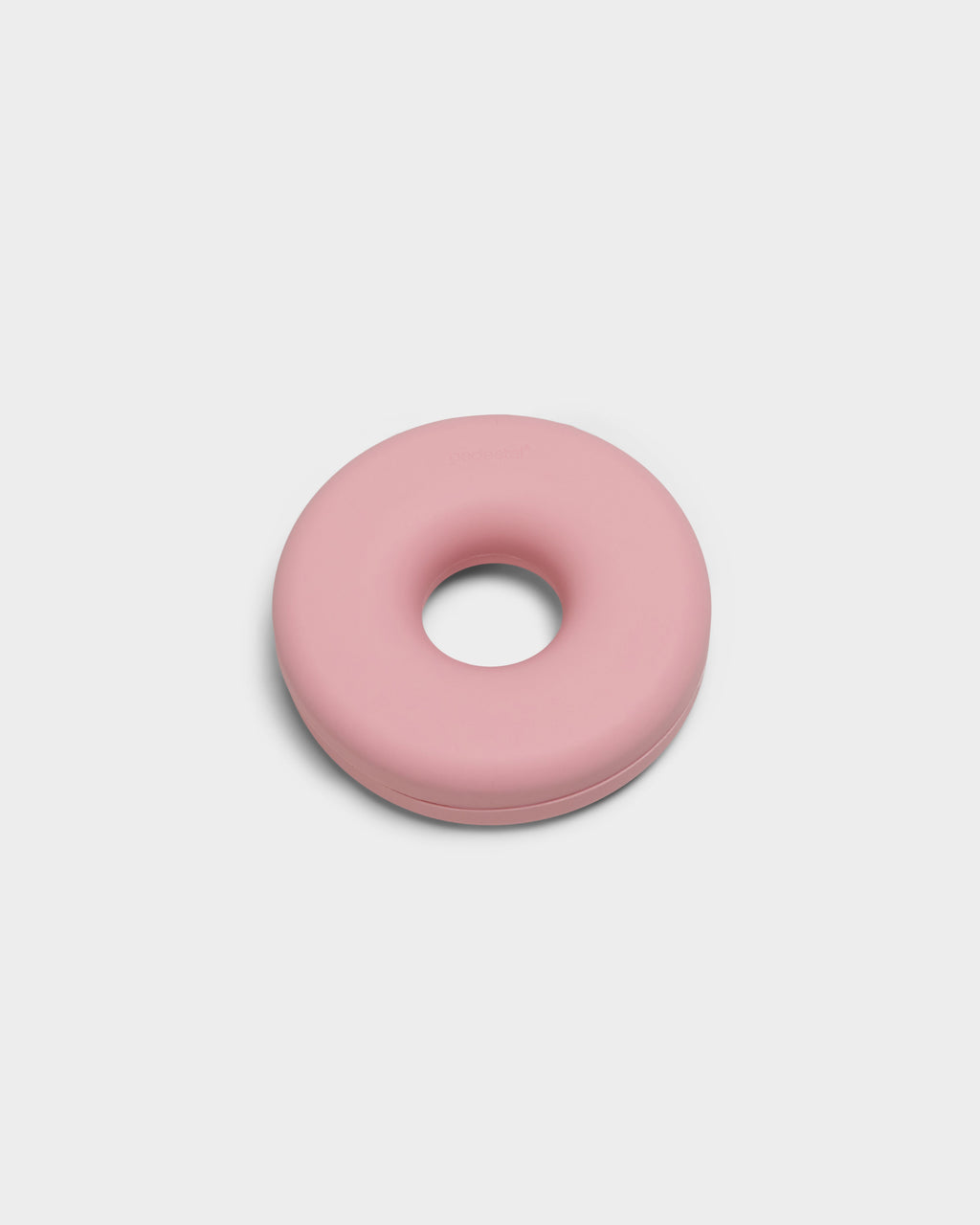 Bubble Gum pink Cable Bagel cable manager, studio packshot at an angle showing the donut-shaped silicone ring and center hole