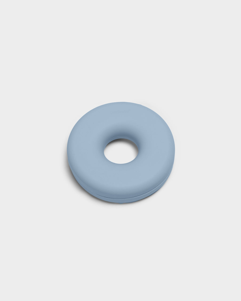 Powder Blue Cable Bagel cable manager shown at an angle in a studio packshot, donut-shaped silicone with center hole