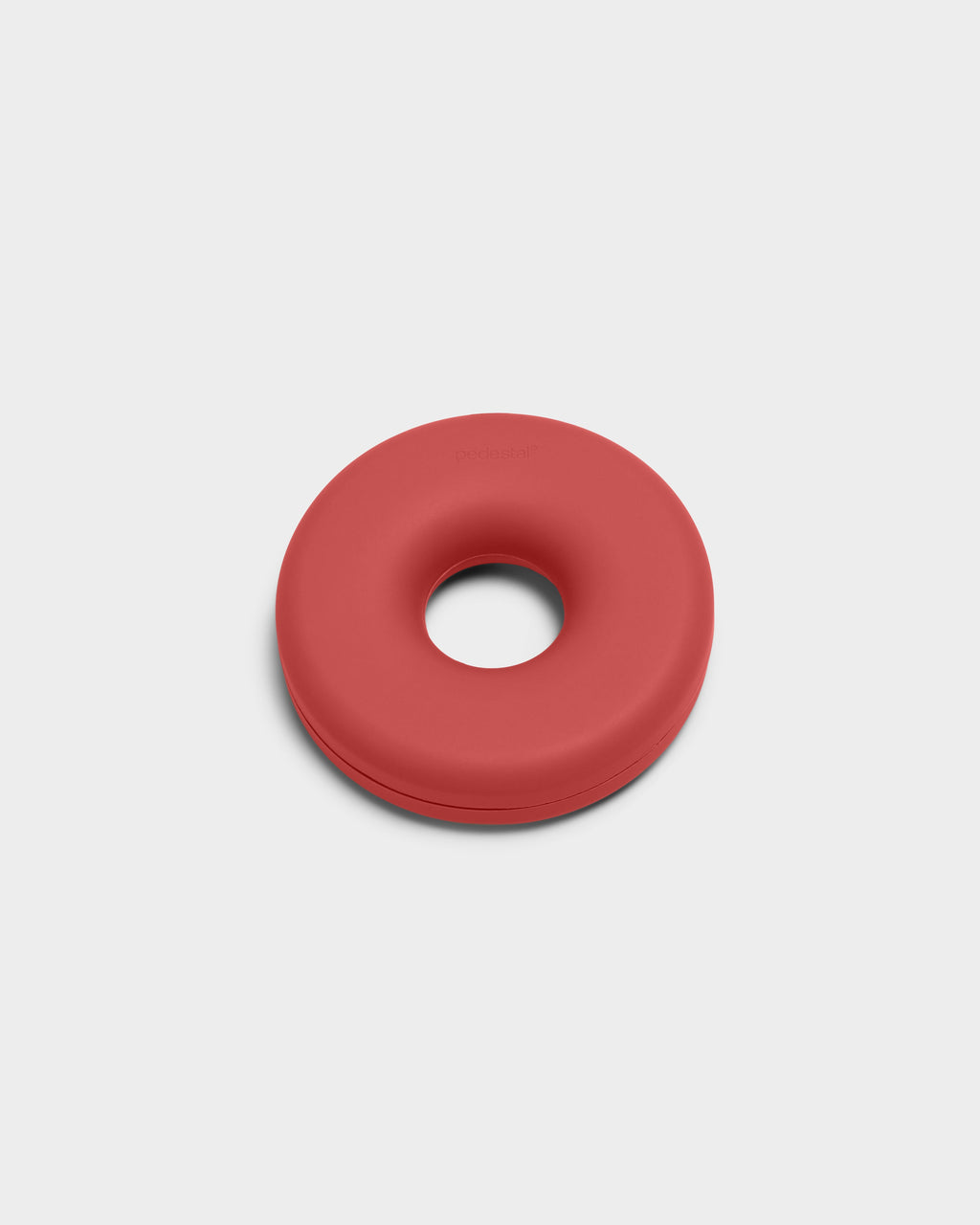 Cable Bagel in Burnin' Red, a donut-shaped silicone cable manager shown at a slight angle in a studio packshot