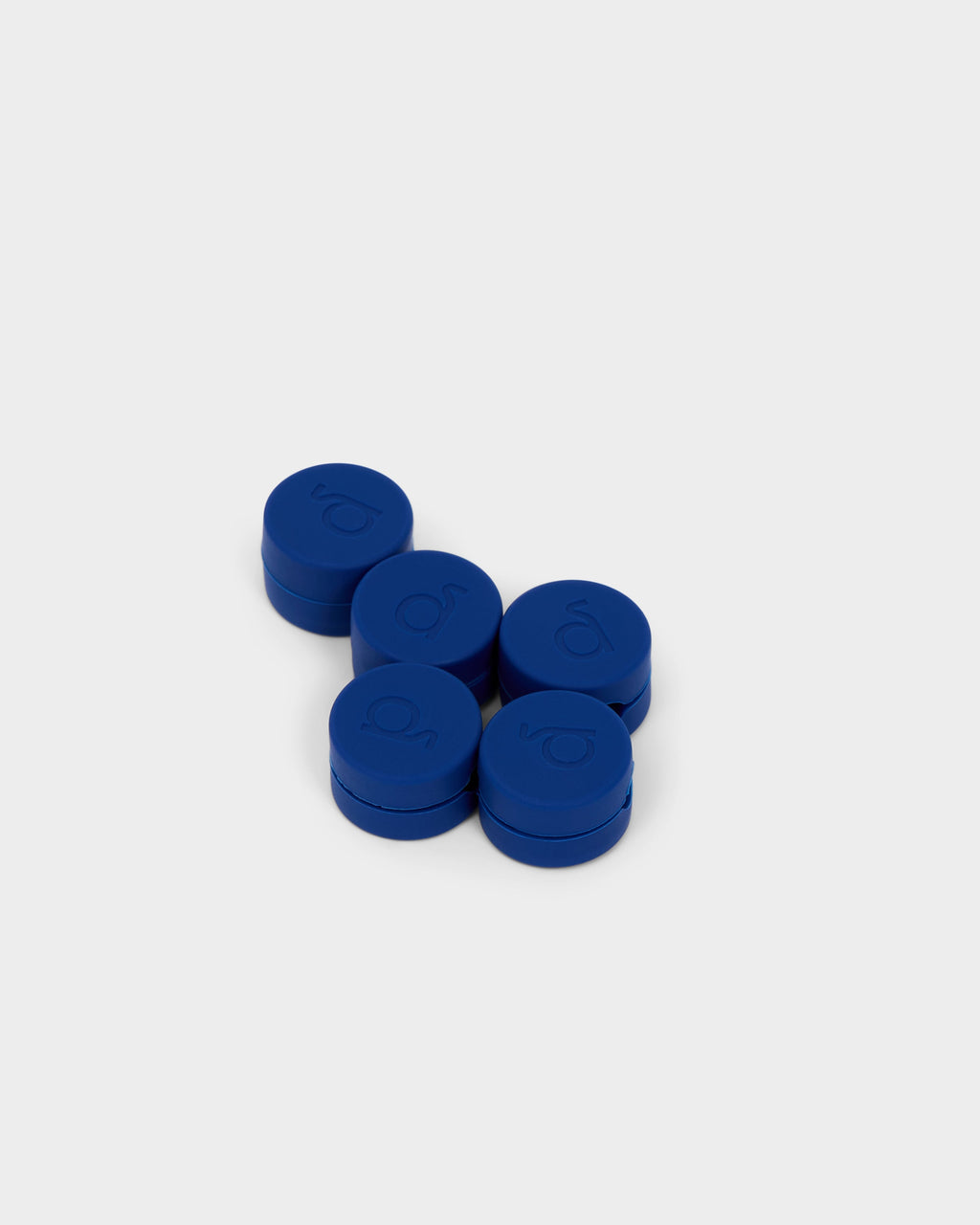 Five round Ultra Marine cable clips with embossed logos, arranged in a cluster on a light studio background
```