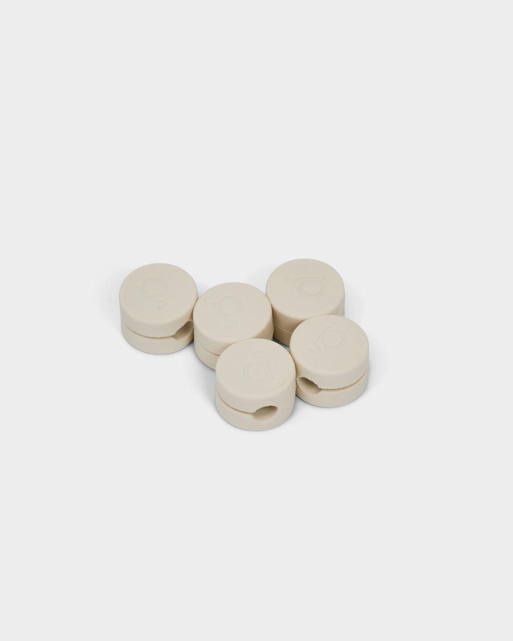 Five round Cable Clips in Pearl arranged in a cluster on a white studio background, shown at a slight angle