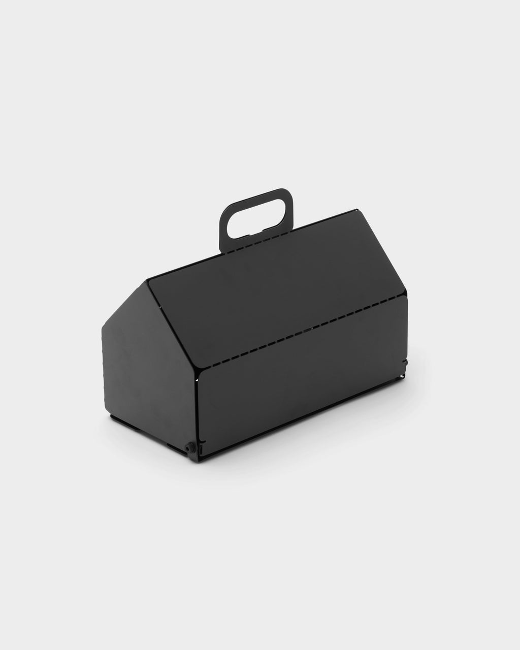 Charcoal Cable House studio packshot at three-quarter angle, house-shaped metal cord cover with cutout carry handle