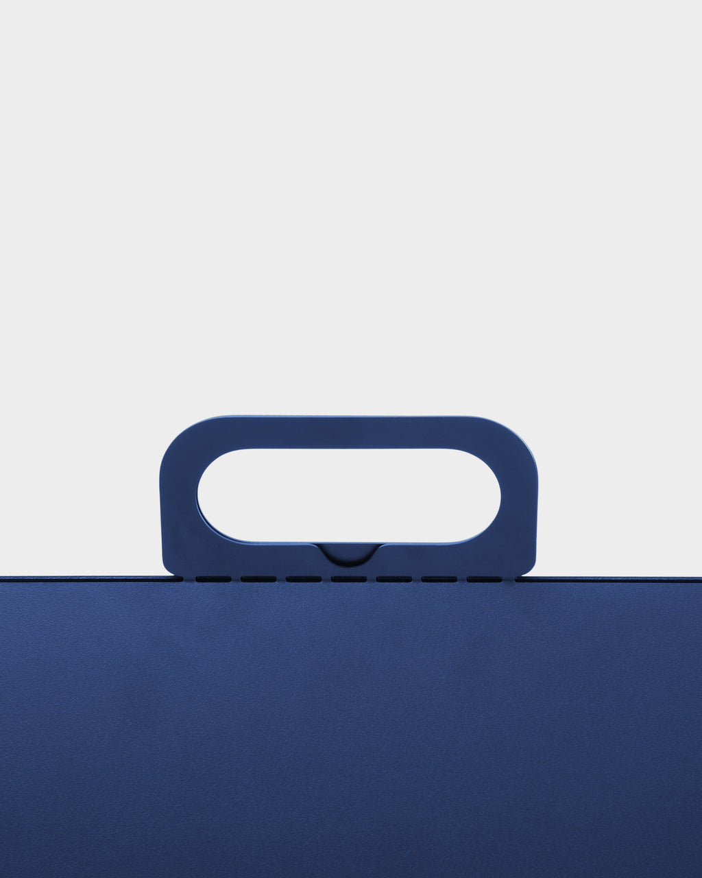 Close-up studio shot of the Ultra Marine Cable House lid, showing its rounded carry handle and slotted top edge