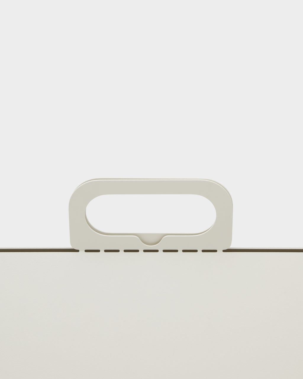 Close-up studio detail of the Cable House in Pearl, showing its rounded oval handle rising above a perforated edge