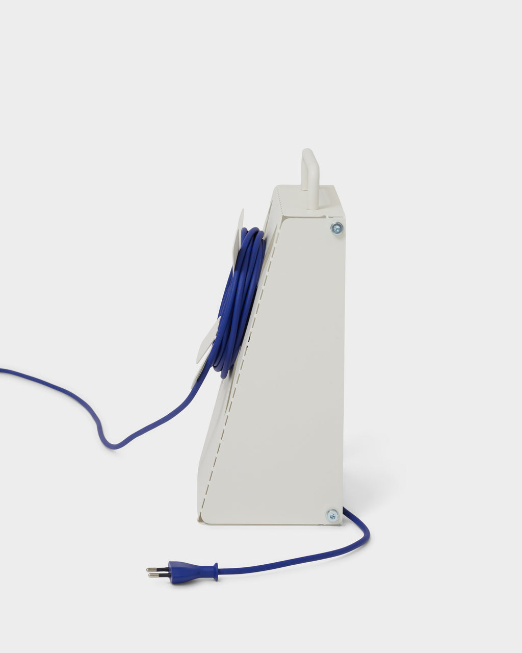 Side profile studio shot of the Pearl Cable Stand, wedge-shaped metal frame with blue cable coiled and plug trailing