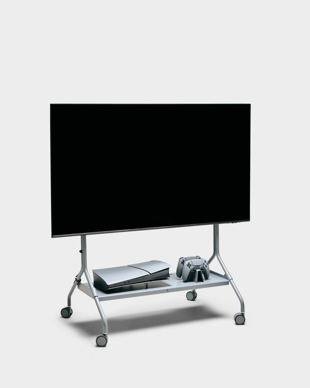 Legacy Gray Cable Tie keeps cords tidy on a rolling TV cart studio setup with mounted flatscreen, console and controllers