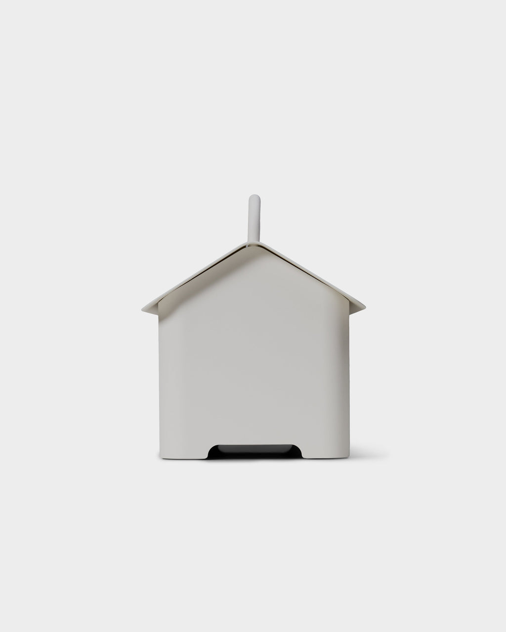 Rear view studio packshot of the Cable Villa in Pearl, house-shaped cable box with chimney and cord cutout at base