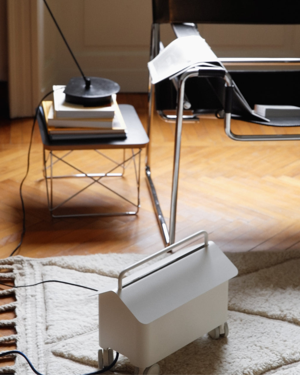 Pearl Cable Villa on wheels tucked beside a woven rug in a sunlit living room with wire side table and cables