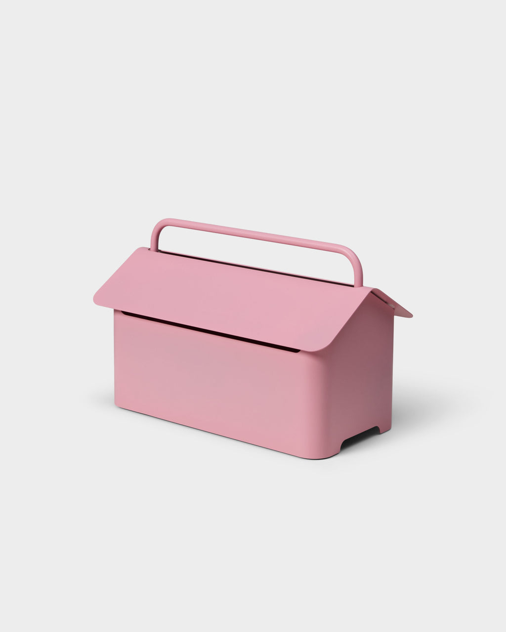 Cable Villa in Bubble Gum pink shown at a three-quarter angle, house-shaped metal cable box with arched carry handle