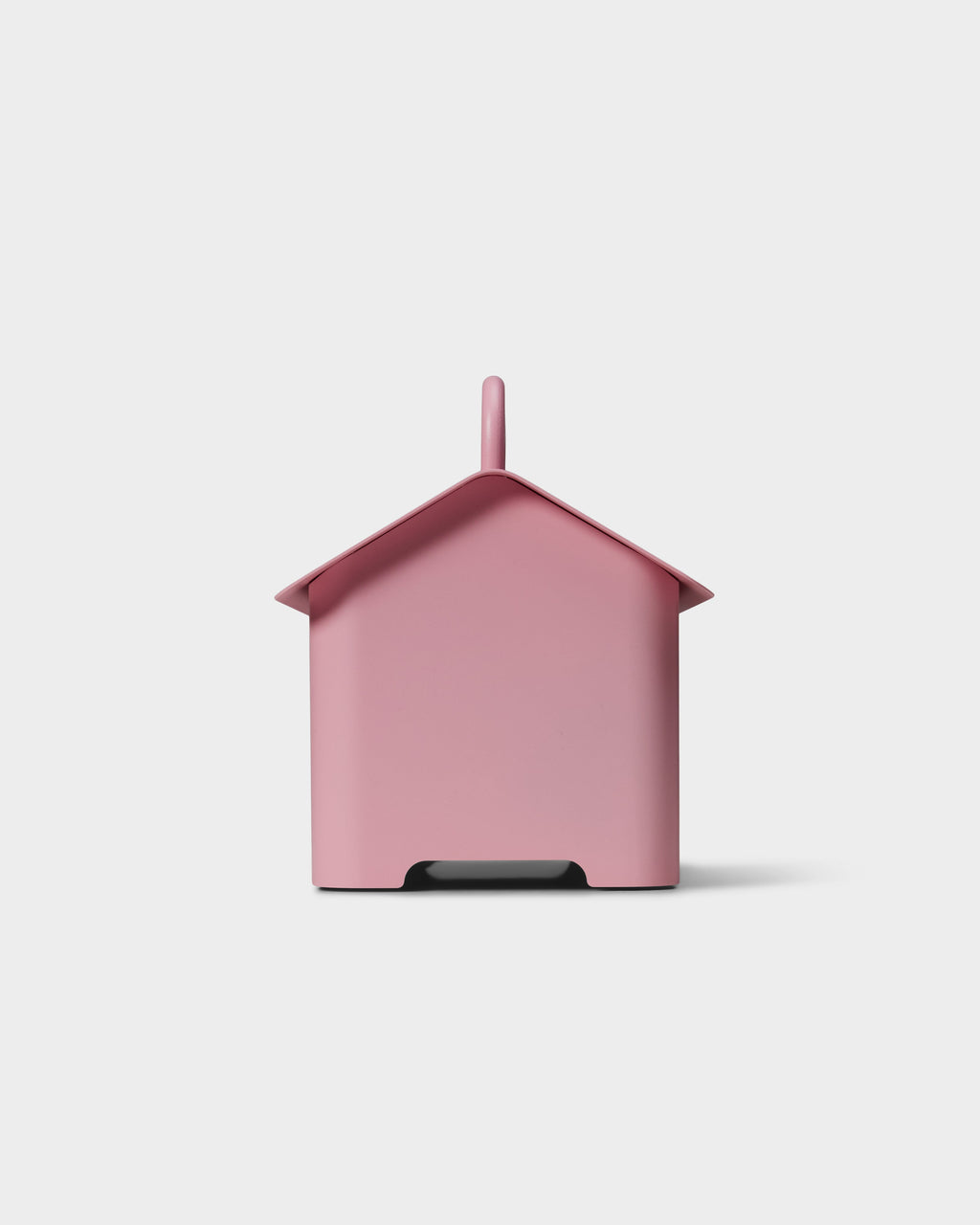 Cable Villa in Bubble Gum pink shown from the back in a studio packshot, house-shaped cover with chimney and cord notch