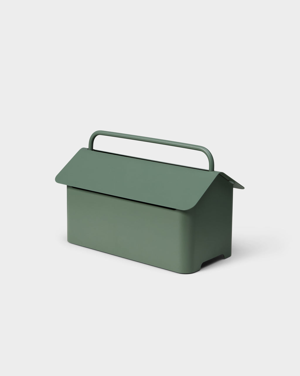 Cable Villa in Mossy Green shown at a three-quarter studio angle, house-shaped metal lid closed with arched handle