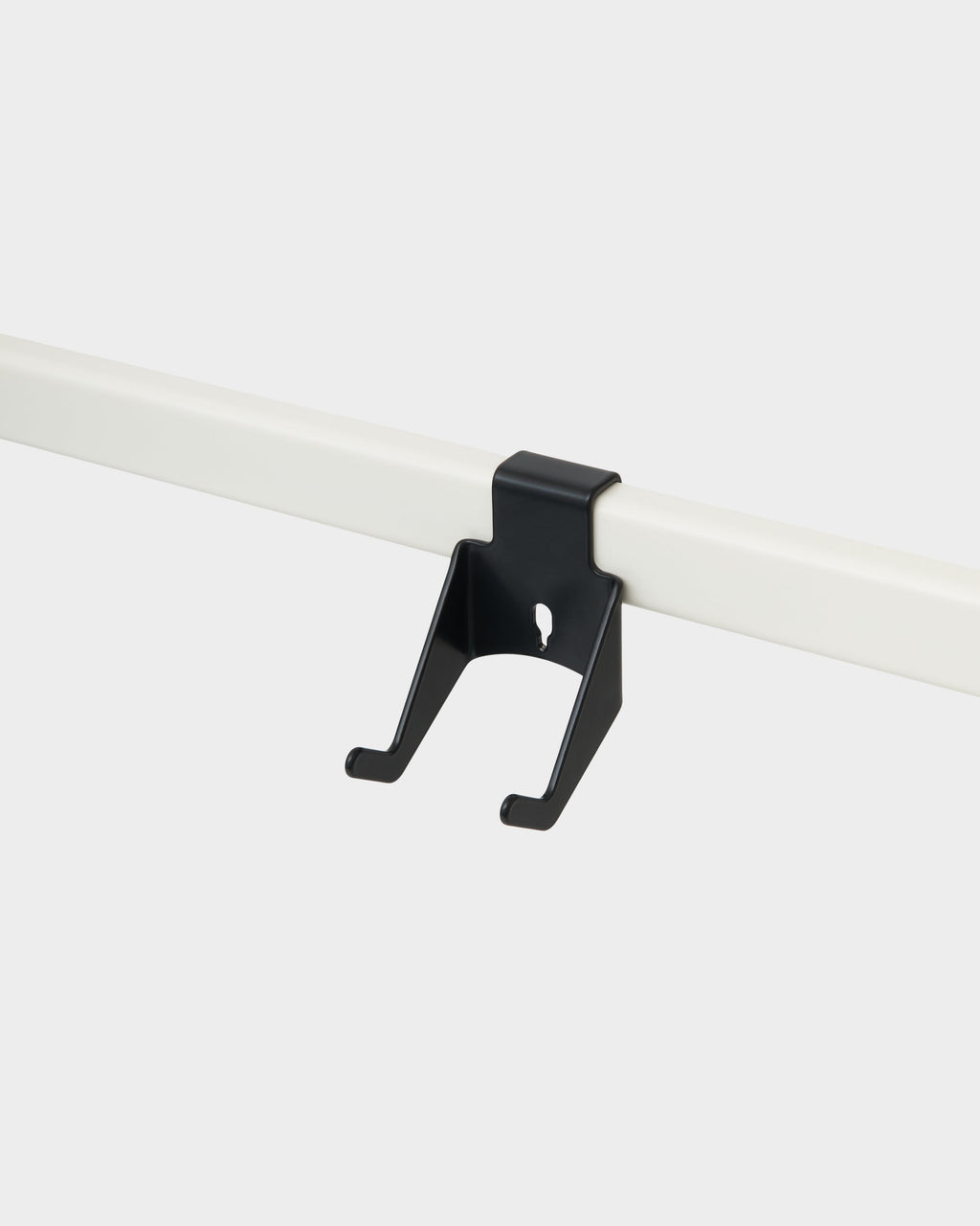 Charcoal Controller Mount clipped onto a white rail in a studio packshot, angled view showing its twin hook prongs