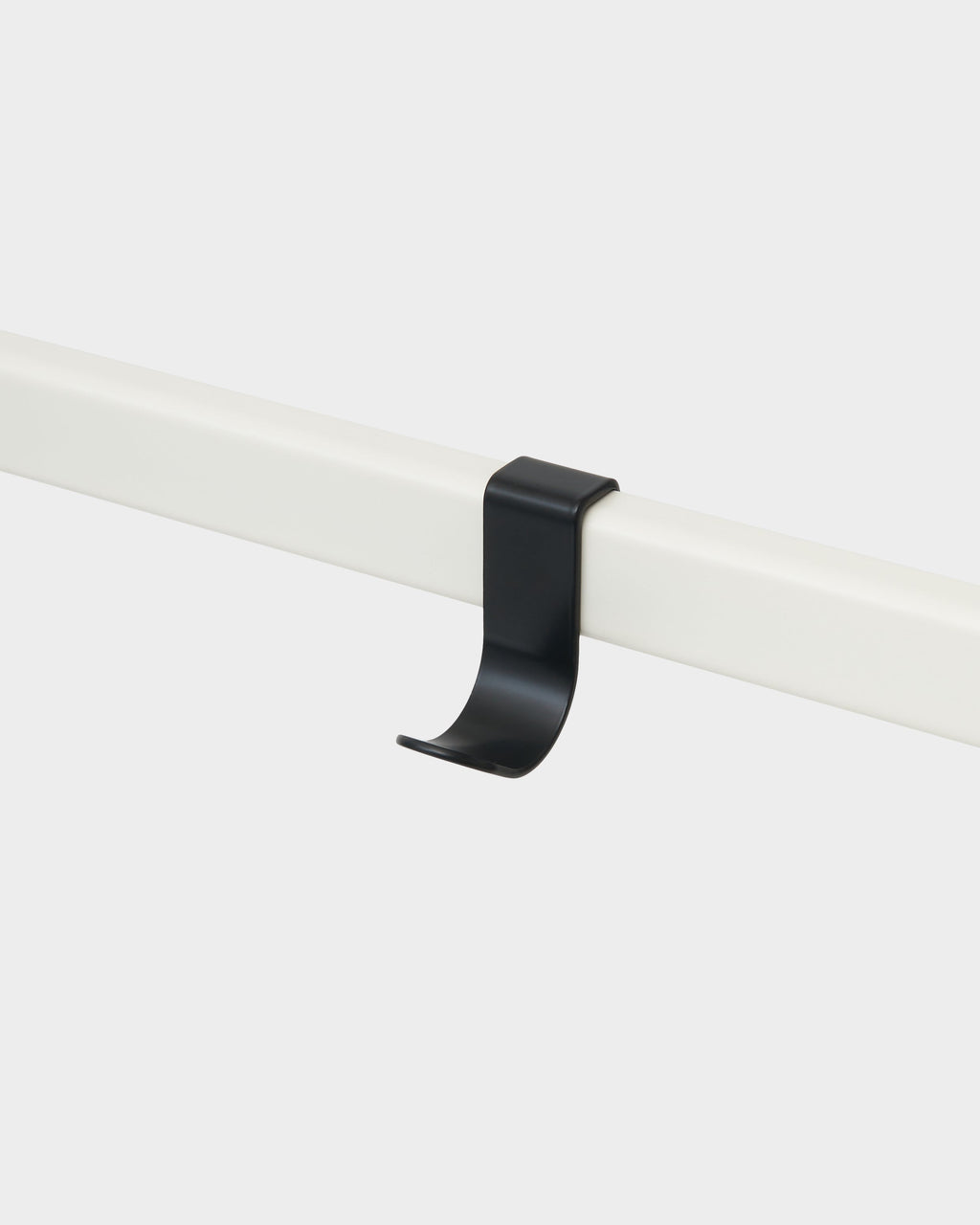 Charcoal Hook Mount clipped over a white rail in a studio packshot, angled view showing its curved hook profile