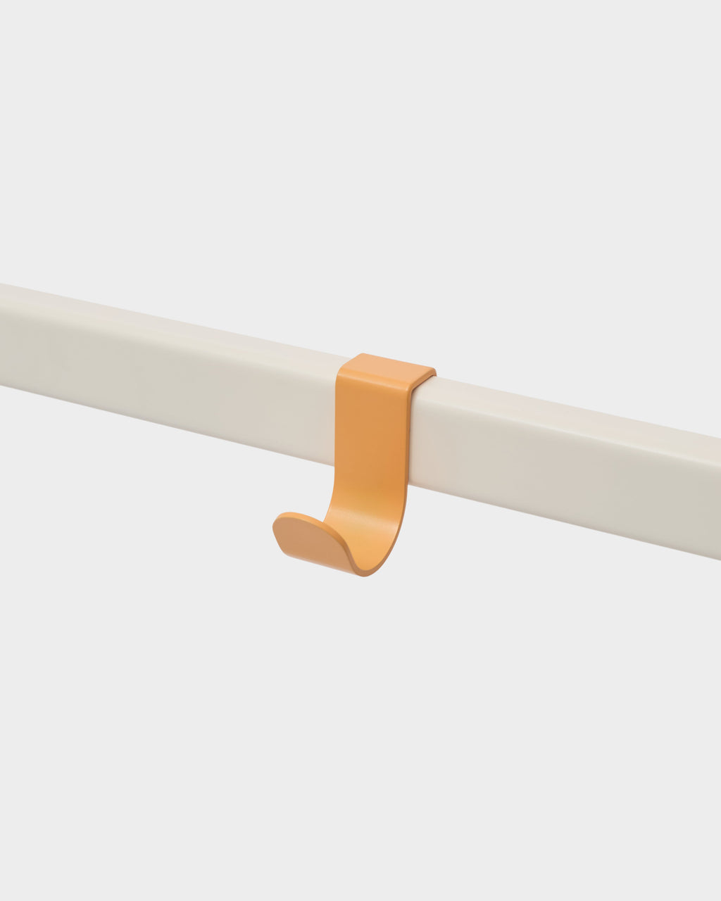 Apricot Hook Mount clipped over a cream rail in a close-up studio packshot, angled side view