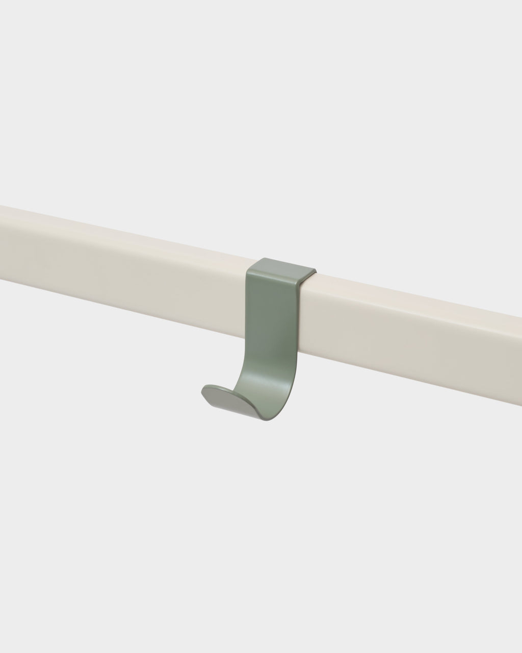 Mossy Green Hook Mount clipped onto a cream rail in a studio packshot, angled close-up of the curved hook
