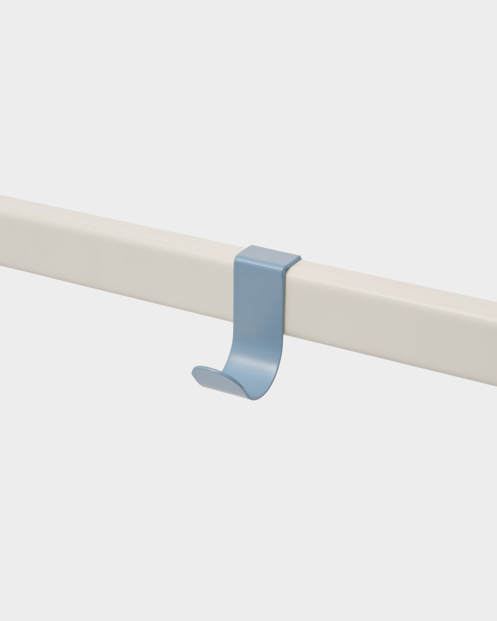 Powder Blue Hook Mount clipped over a cream rail, studio close-up at an angle showing its curved J-shaped profile