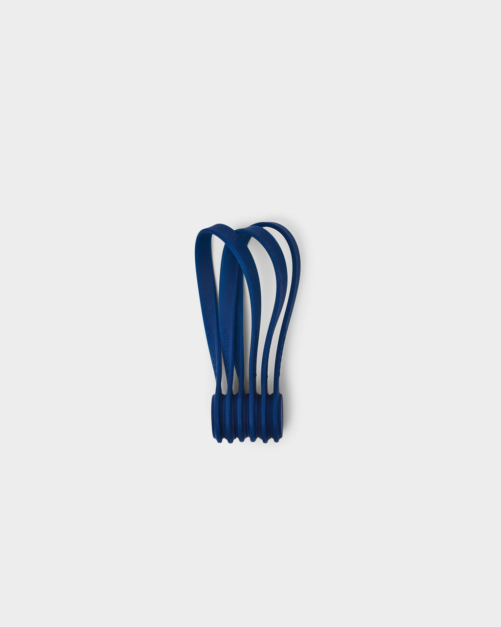 Set of Magnetic Cable Ties in Ultra Marine standing upright in a studio packshot, looped silicone straps joined at the base