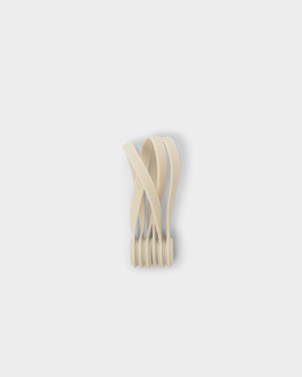 Bundle of Pearl Magnetic Cable Ties standing upright in a studio packshot, curved silicone straps fanning out on grey