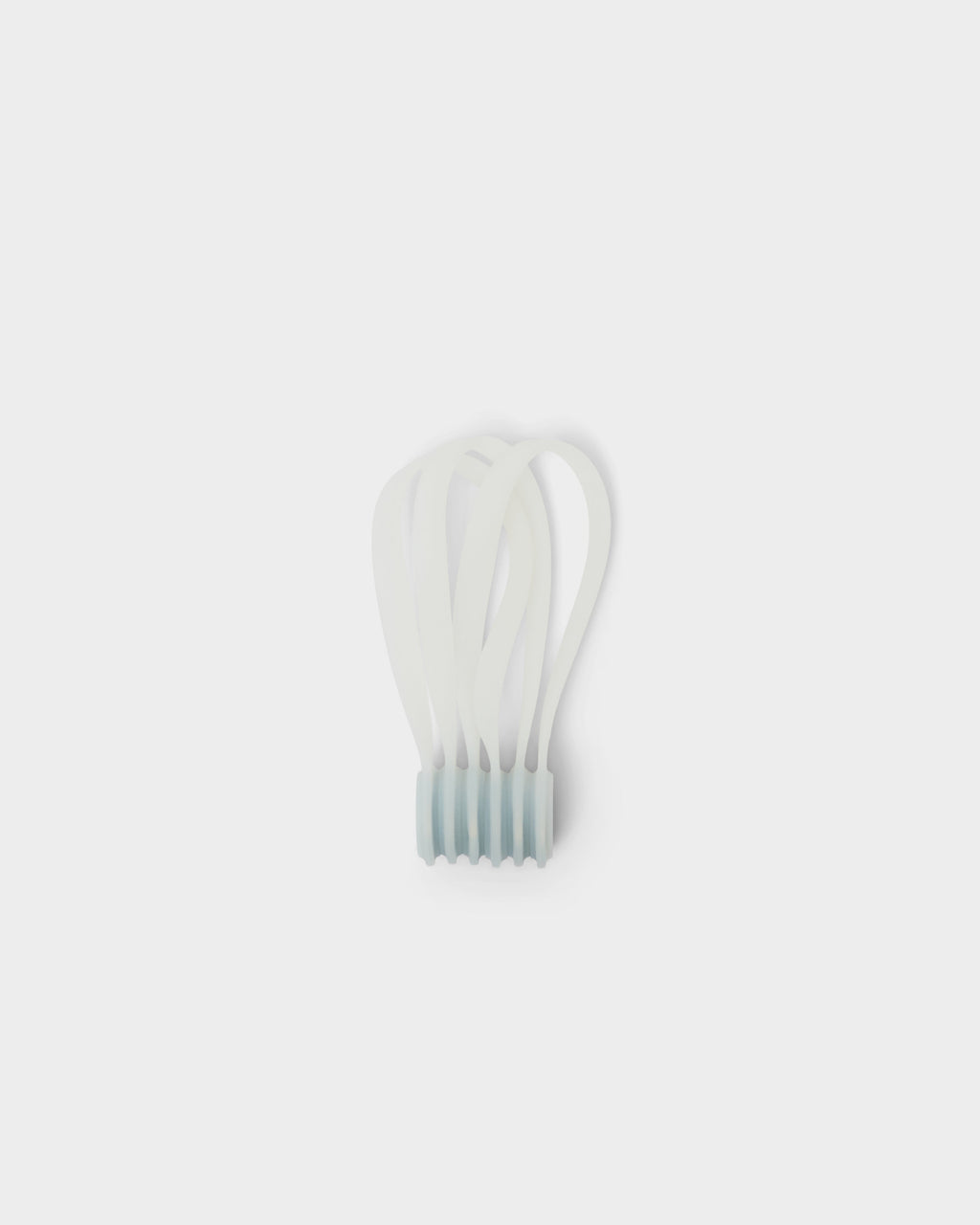 Bundle of Ghost white Magnetic Cable Ties standing upright in a studio packshot, looped straps fanning above the base