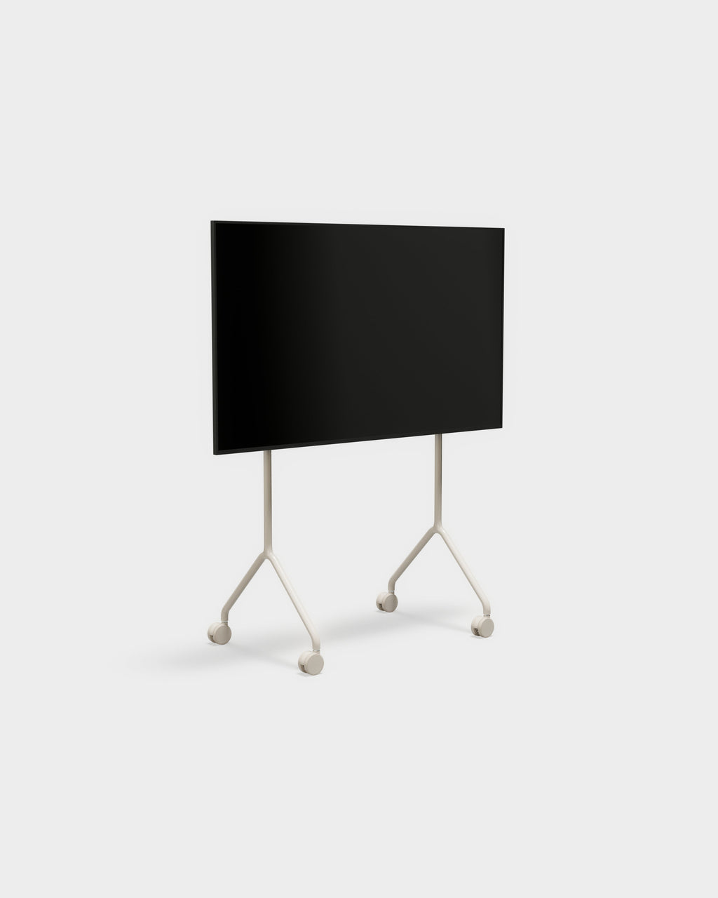 Moon Light TV stand in Oat shown at an angle in a studio, mounted flat-screen TV on slim wheeled Y-shaped legs