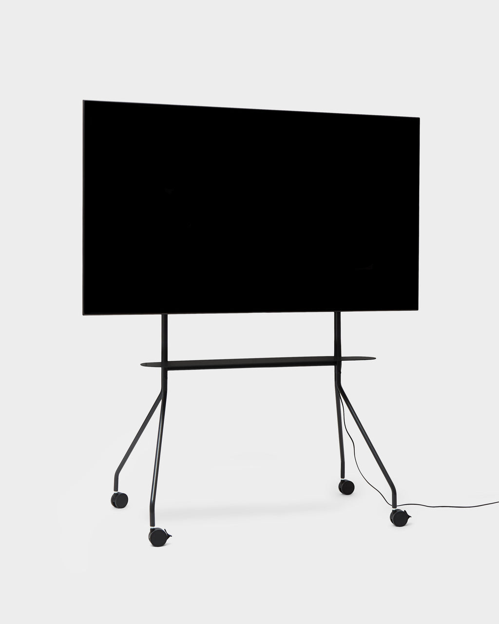 Moon PRO TV stand in Charcoal holding a large flat-screen TV, angled studio packshot with shelf and locking casters