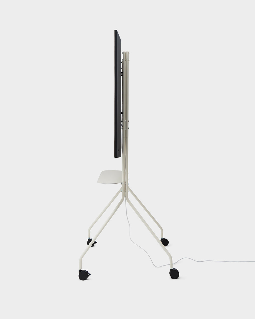 Side profile studio shot of Moon PRO TV stand in Pearl with mounted TV, shelf, locking casters and trailing cable