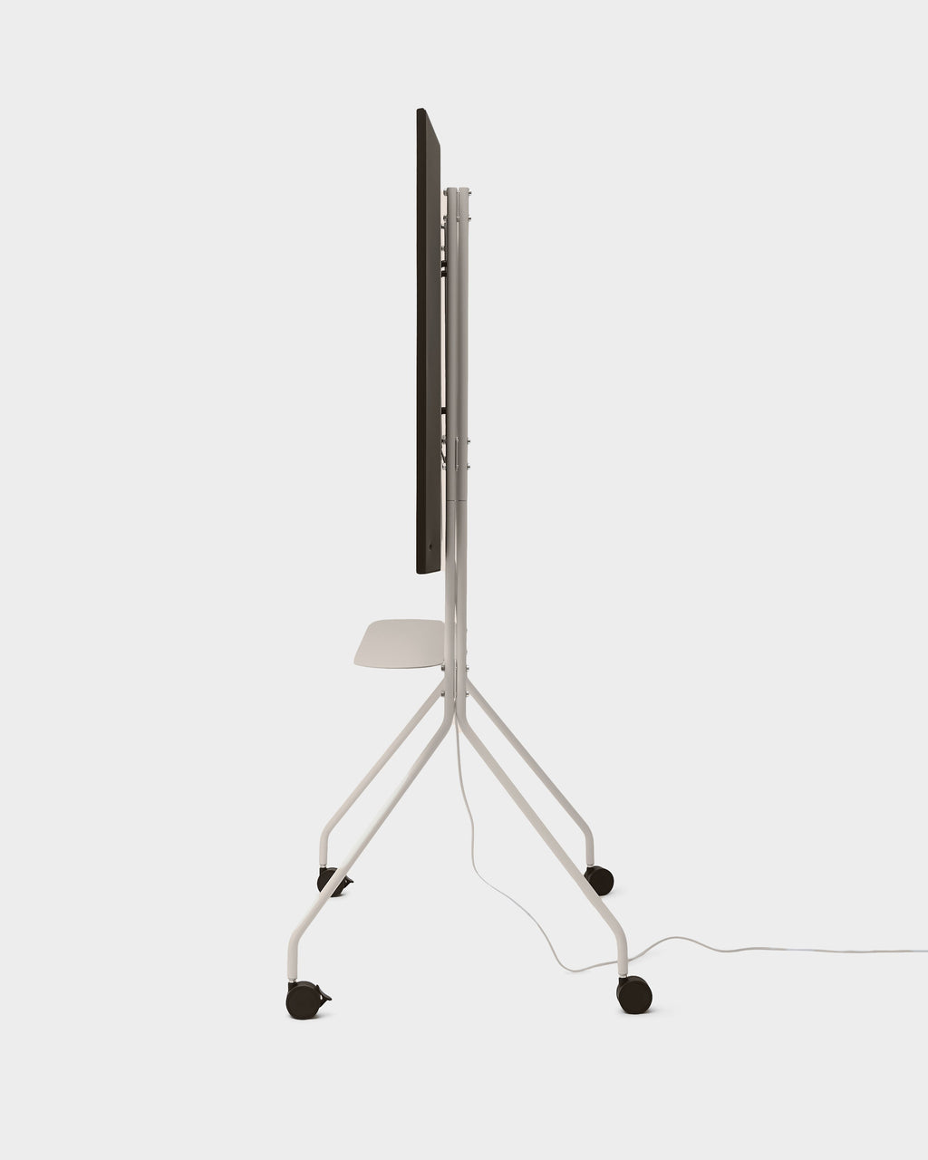 Side profile of the Moon PRO TV stand in Oat, studio packshot with mounted TV, shelf, four locking casters and power cable