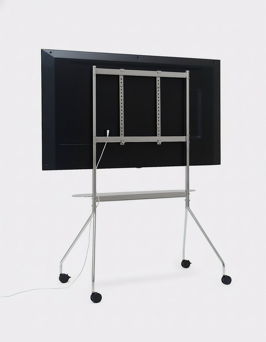 Rear view of Moon PRO TV stand in Chrome holding a mounted flat-screen, showing VESA bracket, shelf and casters