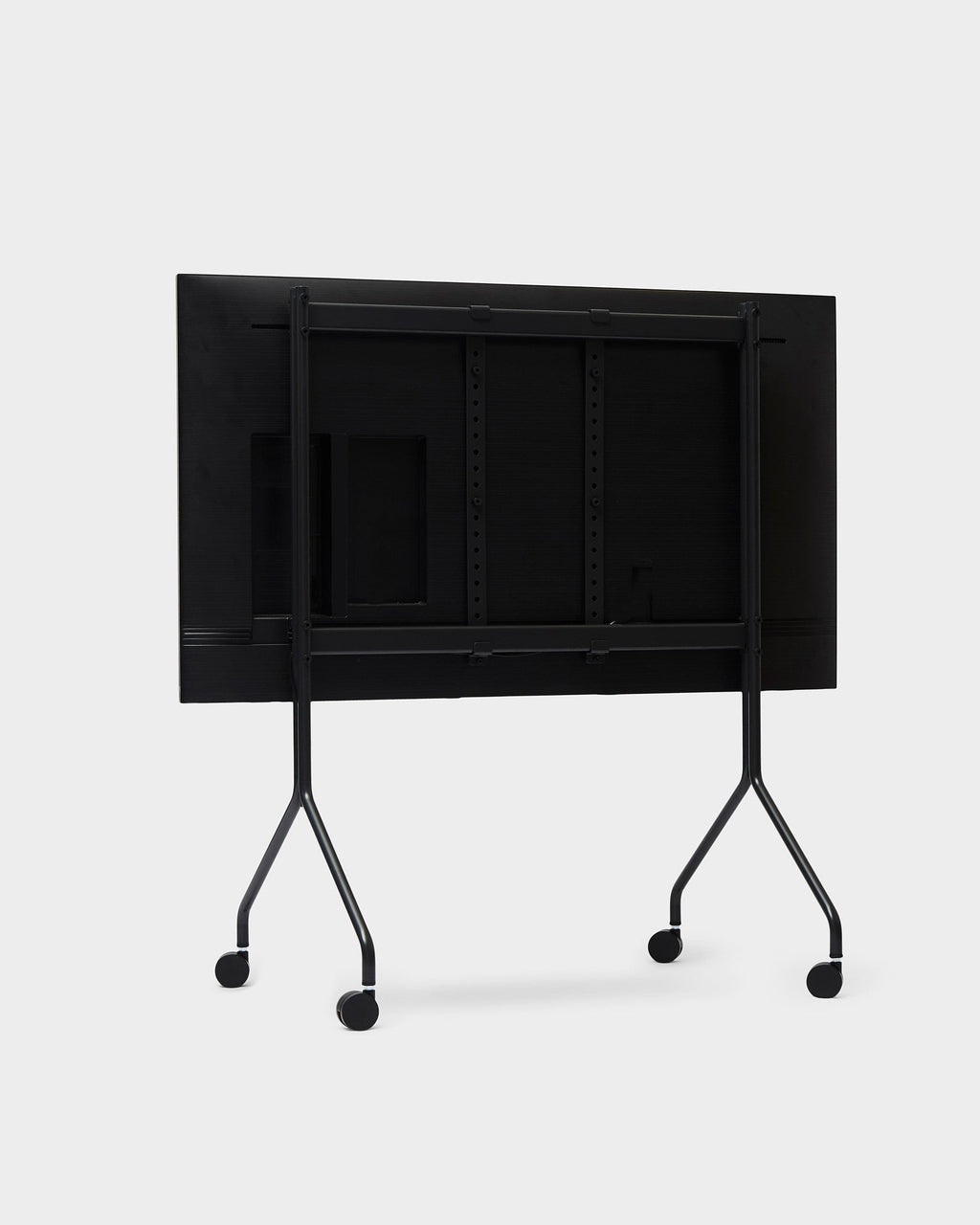 Moon in Charcoal folding table stand with wheels, tilted tabletop upright, rear three-quarter studio view on white