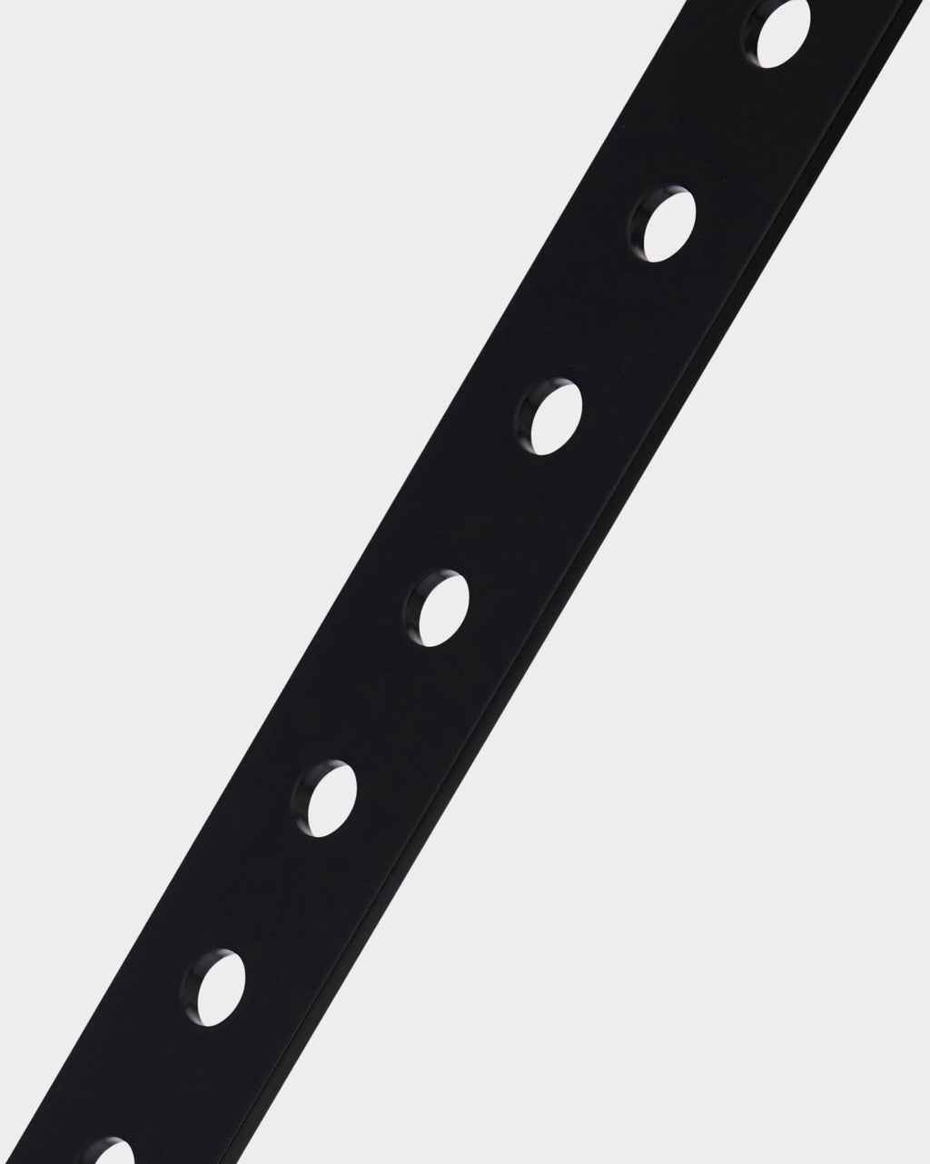Close-up detail of the Moon in Charcoal stand's perforated black metal support column against a studio backdrop