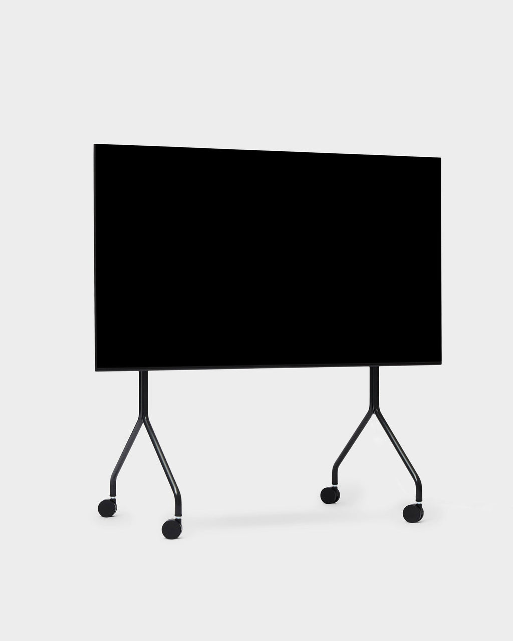 Moon in Charcoal mobile stand with wheels, angled studio view of black display panel on splayed rolling legs