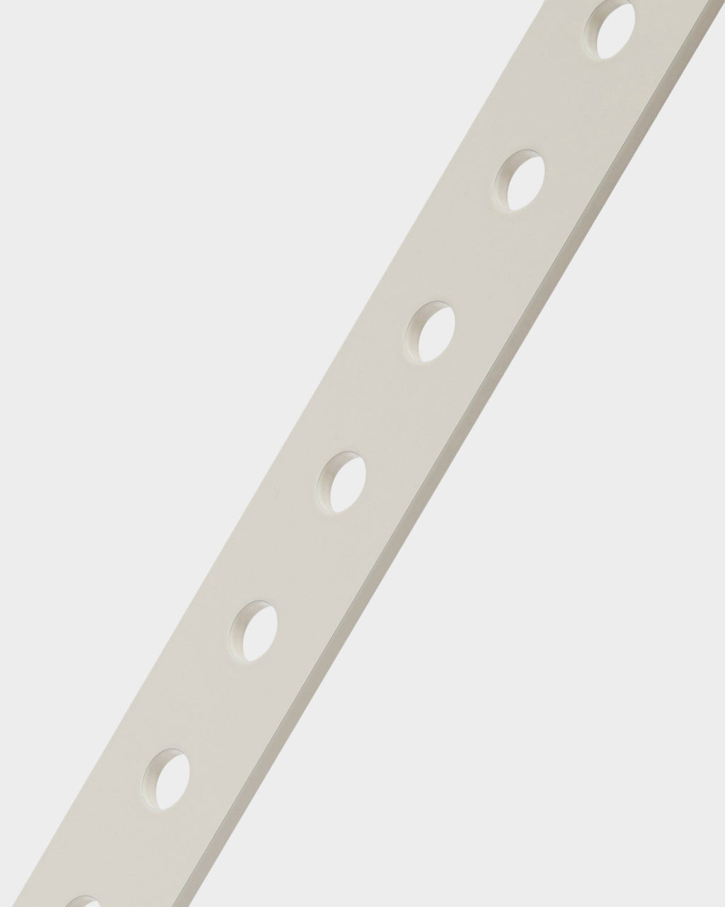 Close-up studio detail of the Moon stand in Pearl, showing the perforated diagonal upright with evenly spaced mounting holes