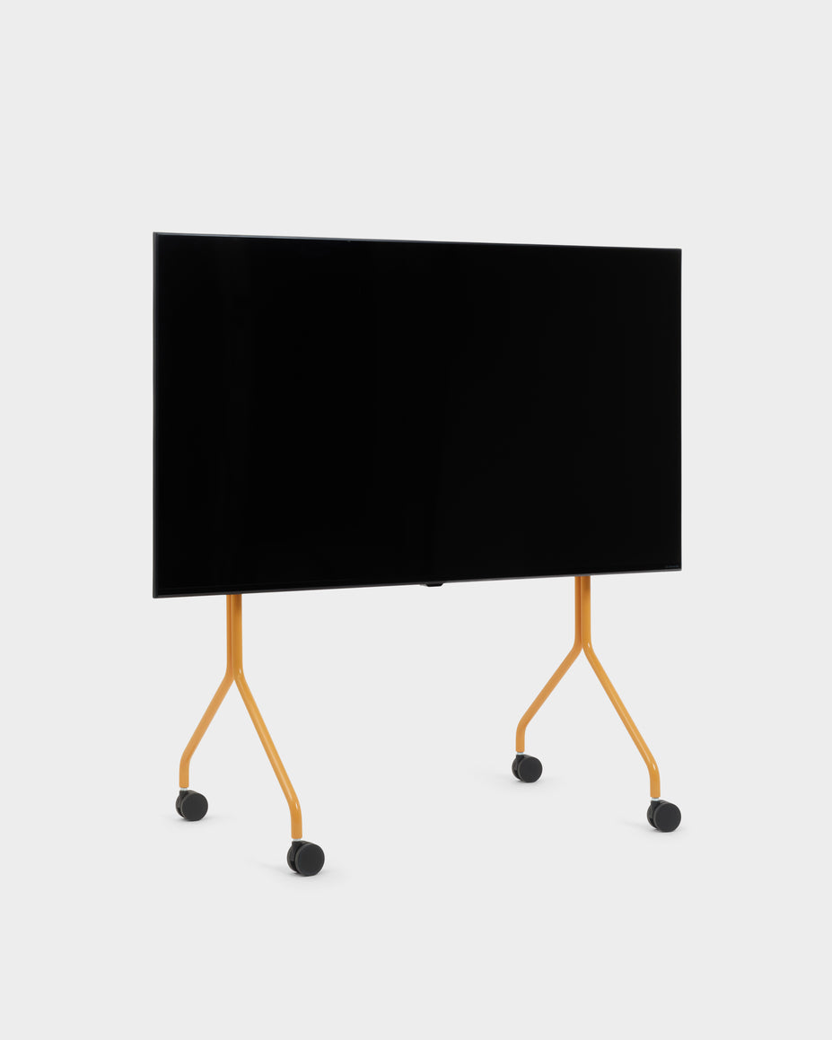 Moon TV stand in Apricot, studio packshot at an angle with mounted flat-screen TV and black caster wheels