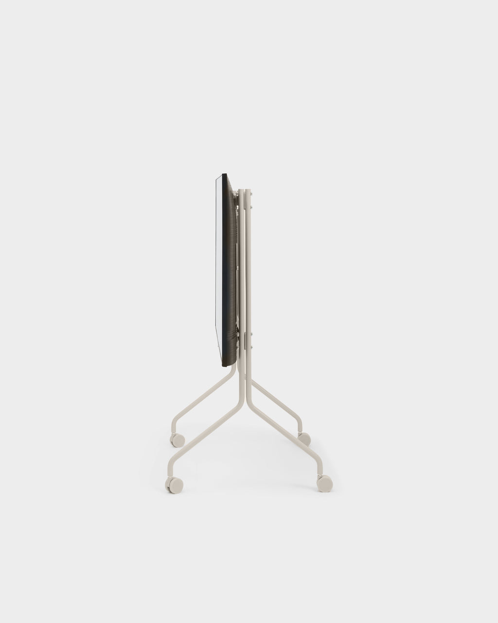 Moon stand in Oat folded flat for storage, side profile studio view showing slim frame and four caster wheels