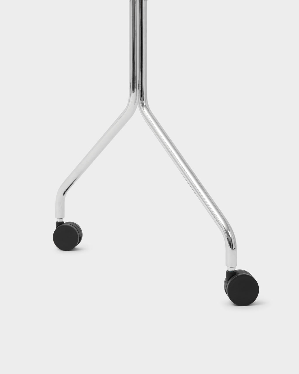 Close-up of the Moon chrome stand's V-shaped base and black caster wheels, studio packshot on light grey