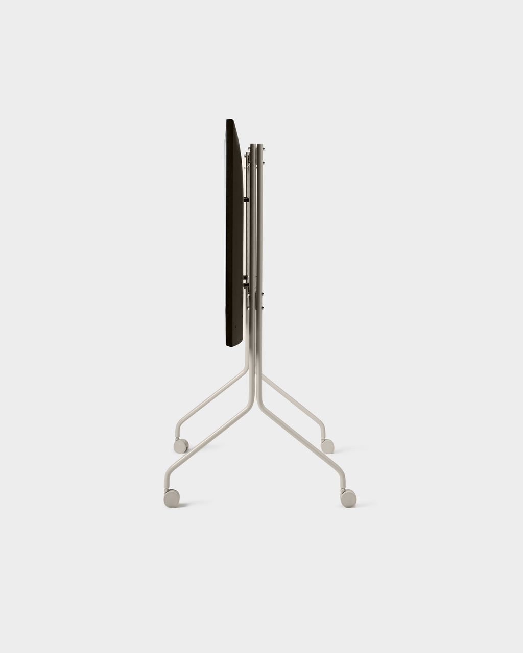 Moon Tall stand in Oat folded flat, side-on studio view showing slim frame, splayed legs and locking caster wheels