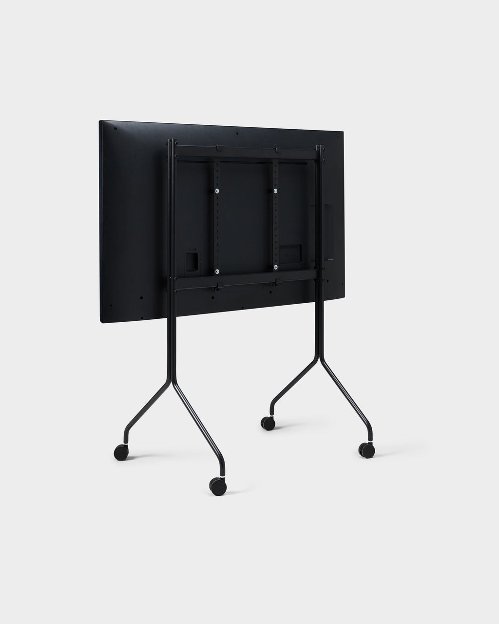 Rear three-quarter studio view of Moon Tall stand in Charcoal with mounted display, showing VESA bracket and wheels
