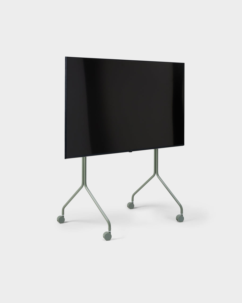 Moon Tall TV stand in Mossy Green shown at an angle in a studio, holding a flatscreen TV on slim wheeled legs