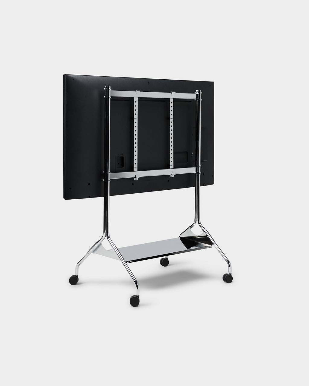 Rear three-quarter view of the Moon Tall stand in Chrome with mounted display, wheels and lower shelf, studio packshot